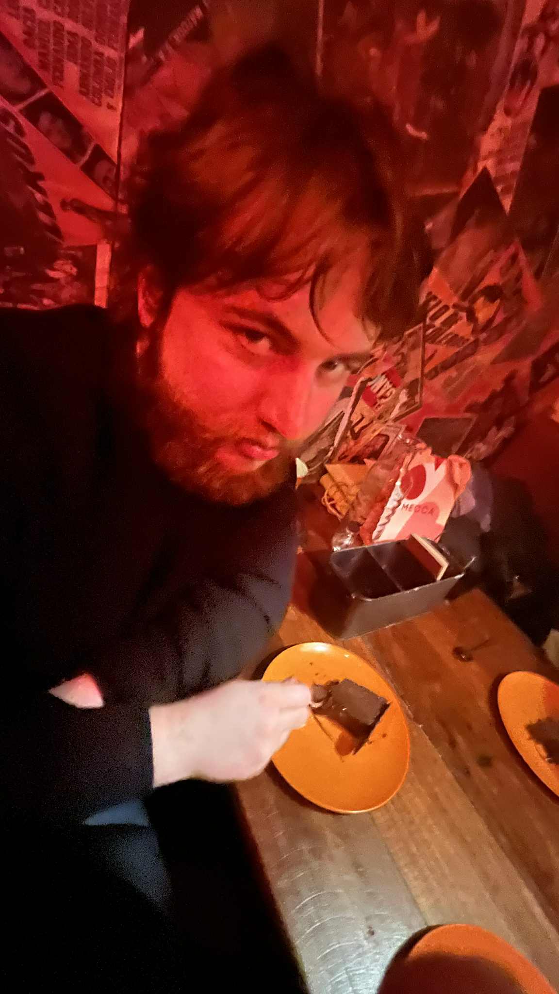 An image of myself in a restaurant eating cake.